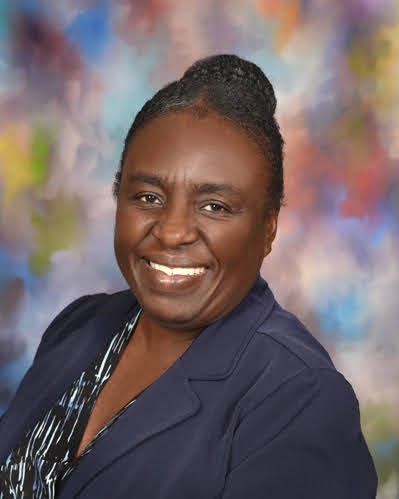 Black woman smiling at the camera.