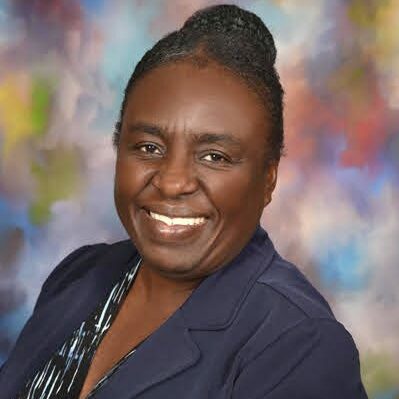 Dr. Ancil Samuel Black woman smiling at the camera.